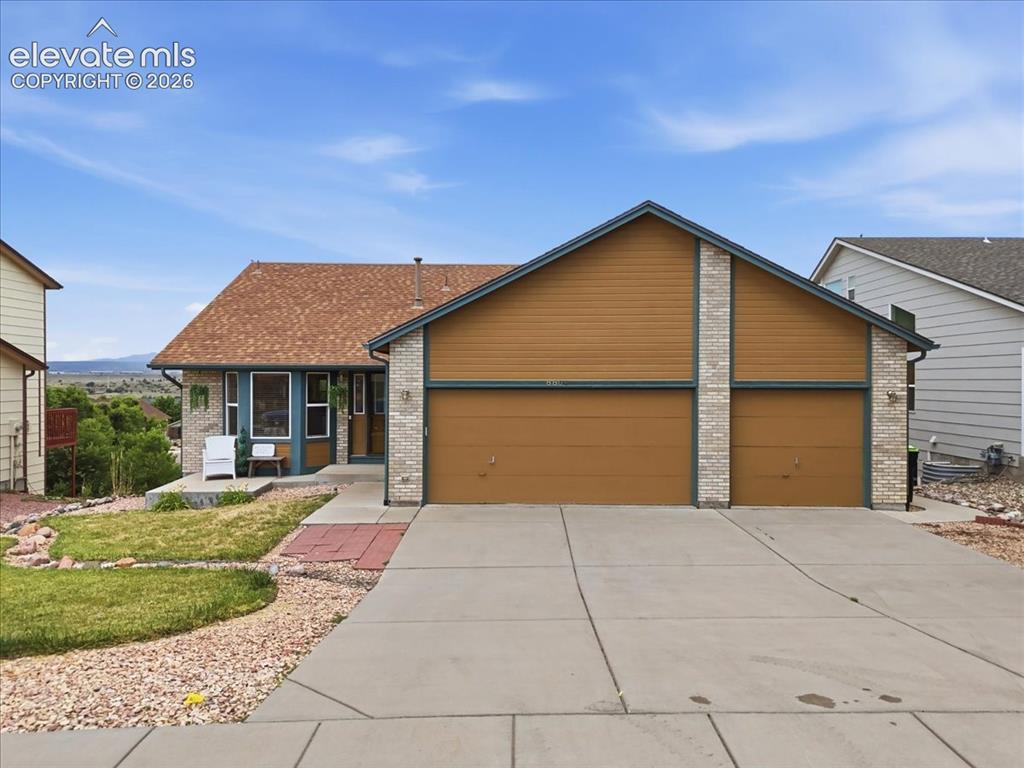 Caption: Front of home with three car garage