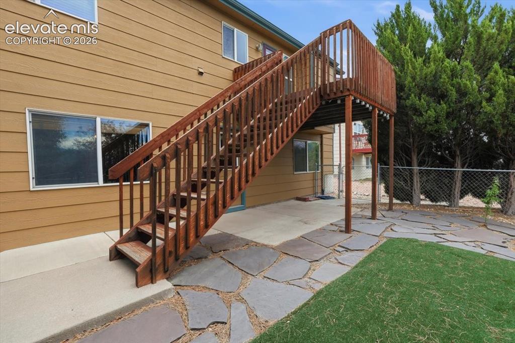 Image 32 of 50: Walkout onto the deck from the main floor, and walkout from the basement on