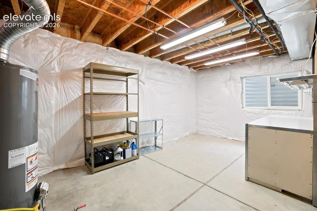 Image 36 of 50: Unfinished basement area used as a workshop