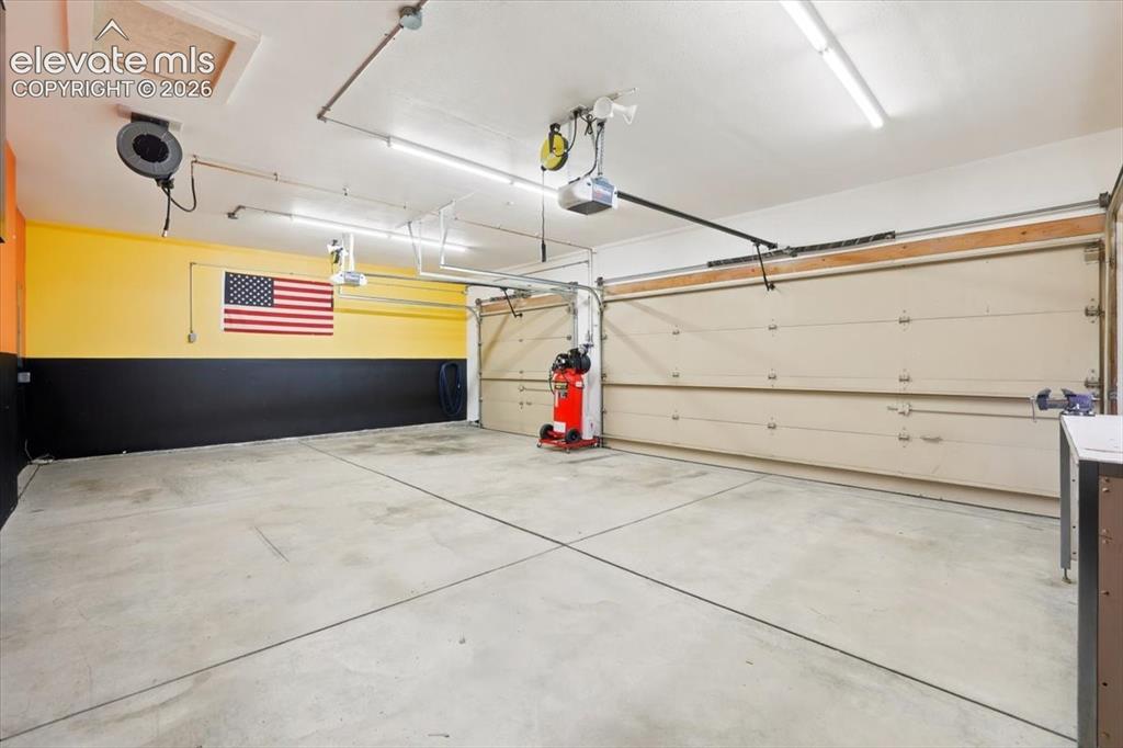 Image 5 of 50: 3 car garage with air compressor system
