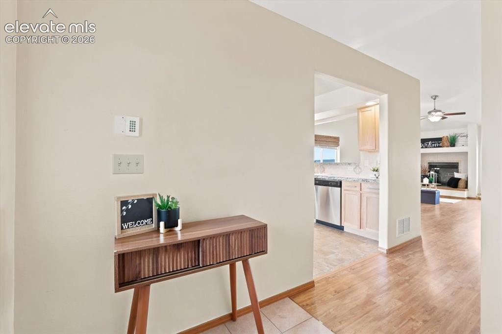 Image 6 of 50: Entry way leads to the kitchen, dining area, and living room