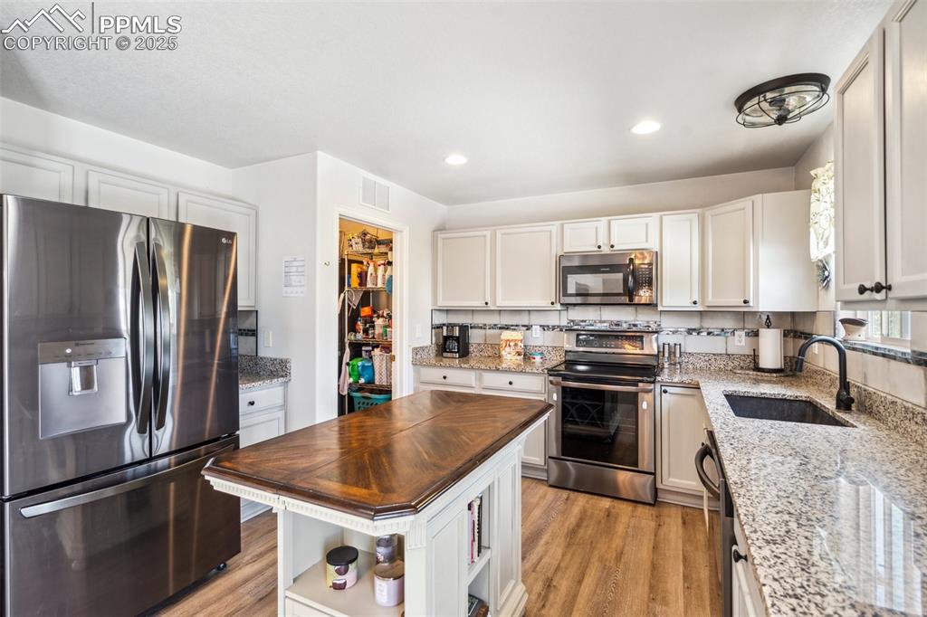 Image 12 of 31: View from the patio doors showing the laundry room doorway