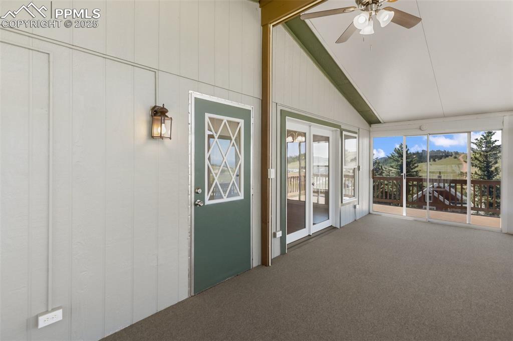 Image 10 of 38: Wide door and French door access from the sunroom. Ceiling fan provides ter