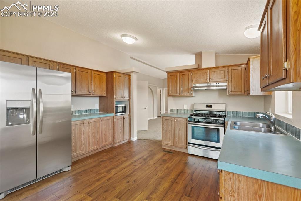 Image 15 of 38: Large dine in kitchen with open flow to the living room.