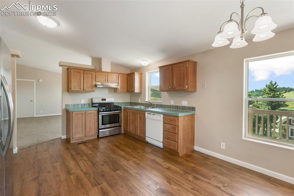 Image 16 of 38: Kitchen with mountain views and plenty of sunshine. Fresh and bright.