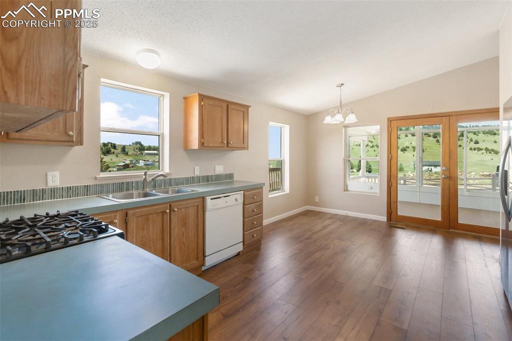 Image 19 of 38: In kitchen dining room space for dinner with evening sunsets.