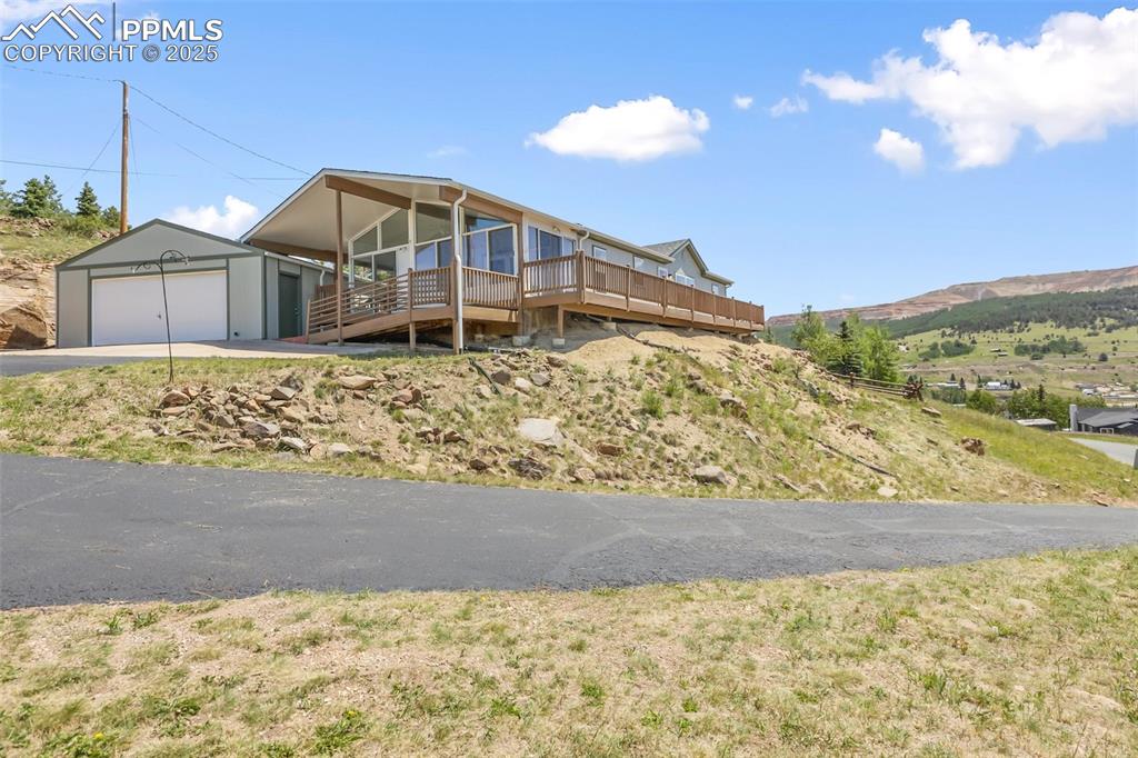 Image 2 of 38: Paved driveway. Home is setback from May St. for added peace and big views.
