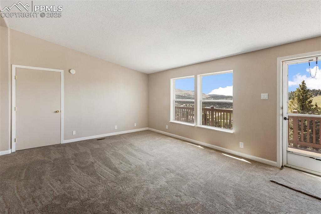 Image 20 of 38: Living room with walk out to front deck.