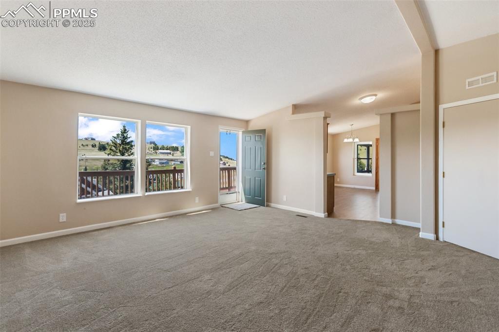 Image 21 of 38: New carpet, interior paint, new lighting fixtures, and windows that bring t