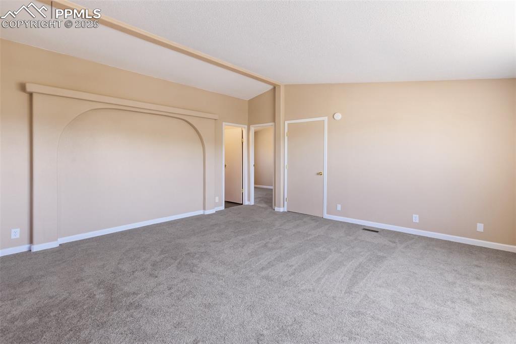 Image 22 of 38: Large living room with two additional guest bedrooms off the main space.