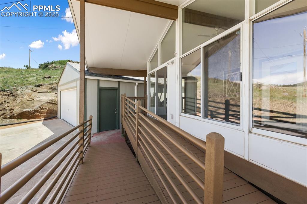 Image 3 of 38: Handicap accessible wide ramp from the driveway and garage. No stairs.
