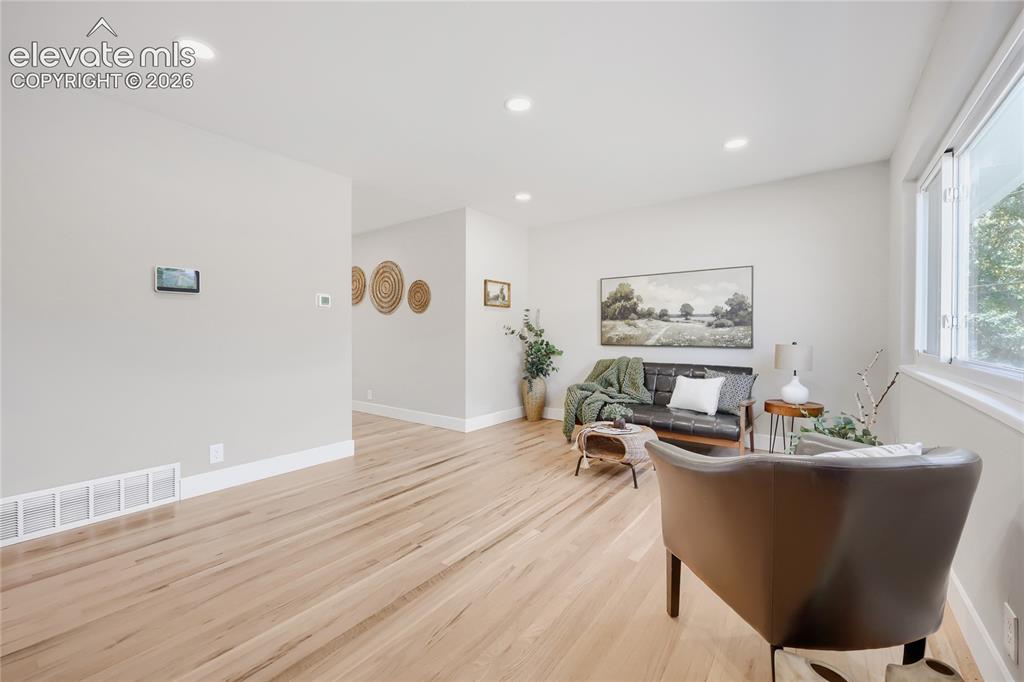 Image 11 of 42: Recessed lighting illuminates the open living space, featuring light wood-f