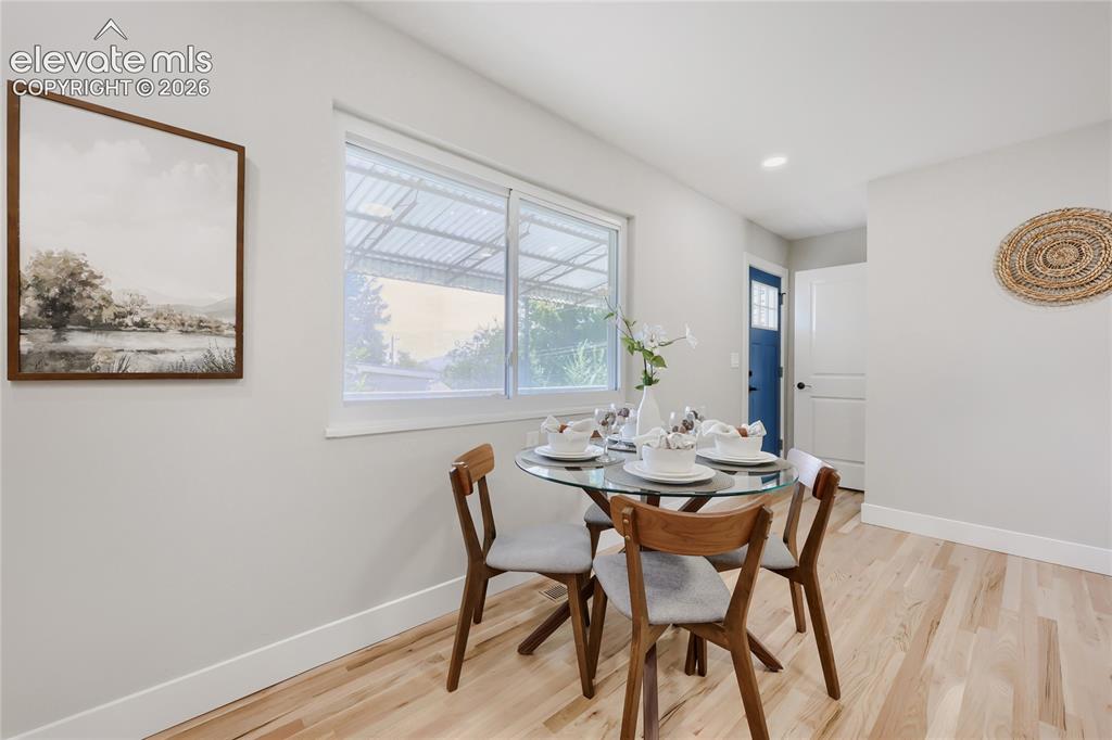 Image 12 of 42: Hardwood flooring, recessed lighting, and a window with natural light