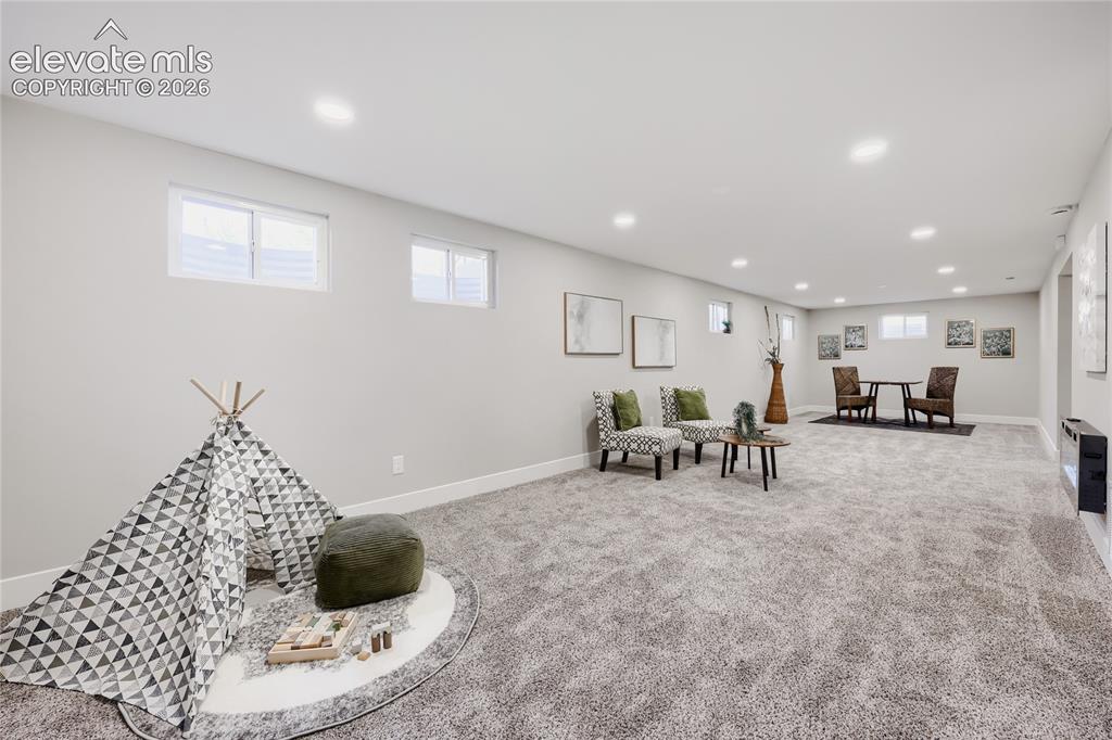 Image 24 of 42: Spacious room featuring light gray carpeting, recessed ceiling lighting, an