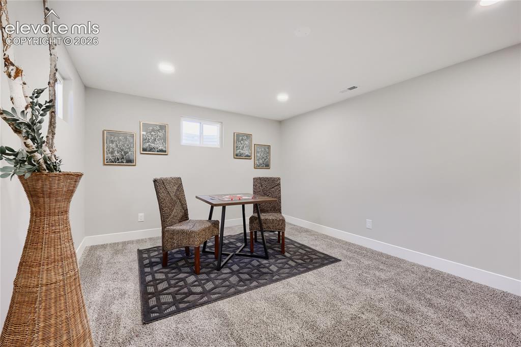 Image 27 of 42: Carpeted flooring with recessed lighting, white walls, and built-in window