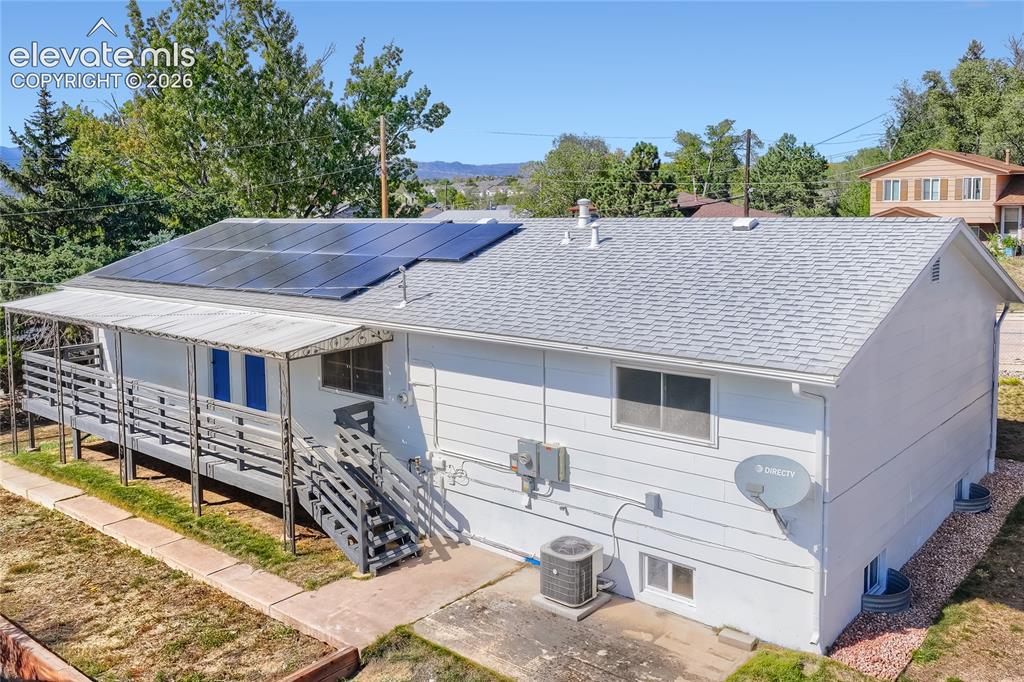 Image 37 of 42: Exterior siding, gray shingle roof, and solar panels