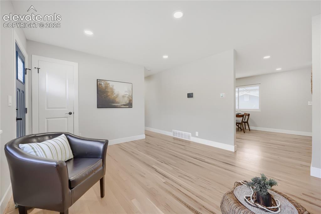 Image 9 of 42: Recessed lighting illuminates wood-finish flooring