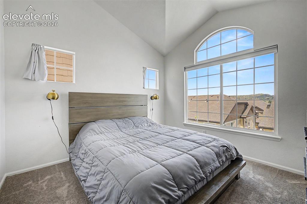 Image 18 of 33: French doors open from the primary bedroom directly onto a private balcony 