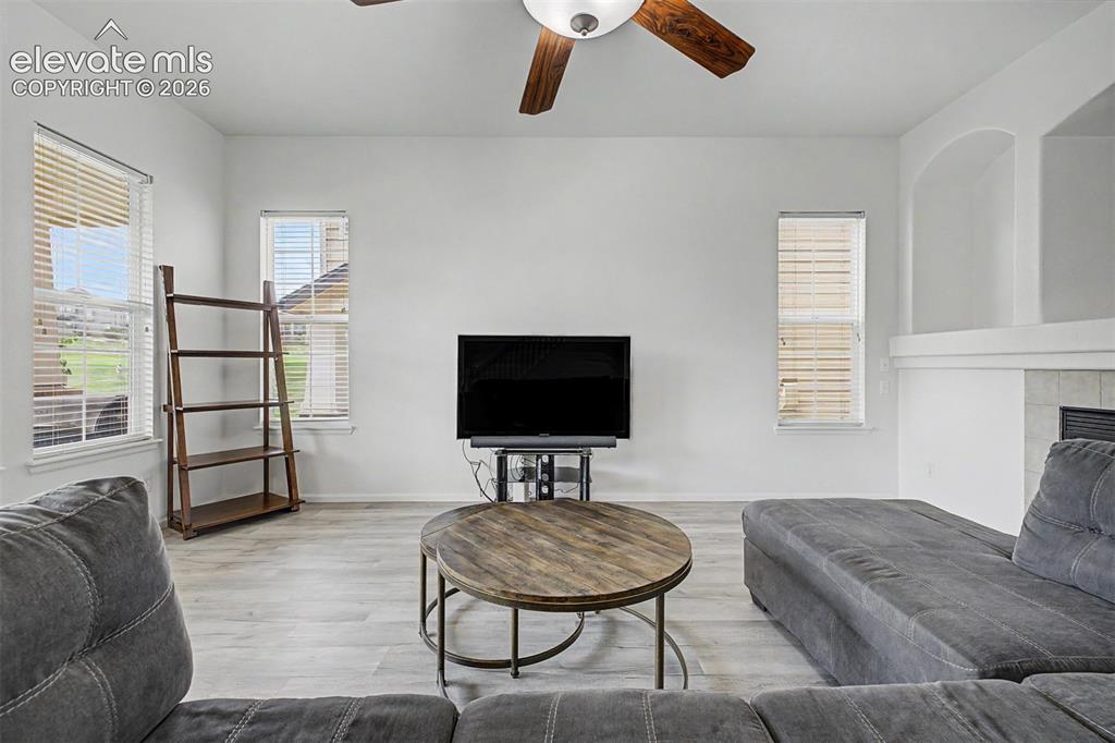 Image 4 of 33: The bright main-level living room offers a relaxed gathering space with wid