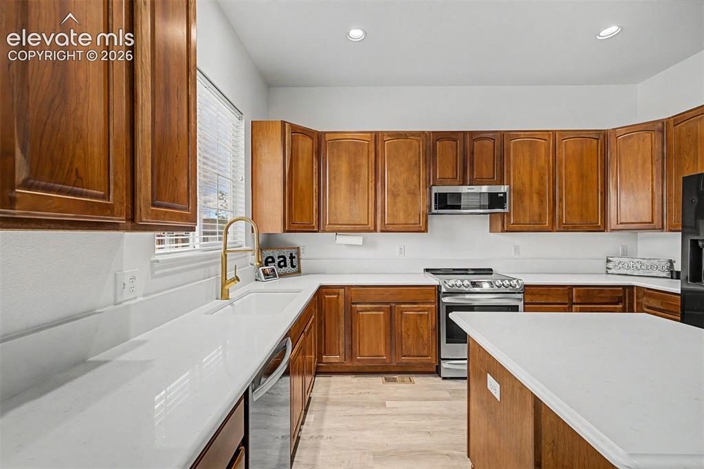 Image 8 of 33: Flooded with natural light from oversized front-facing windows overlooking 