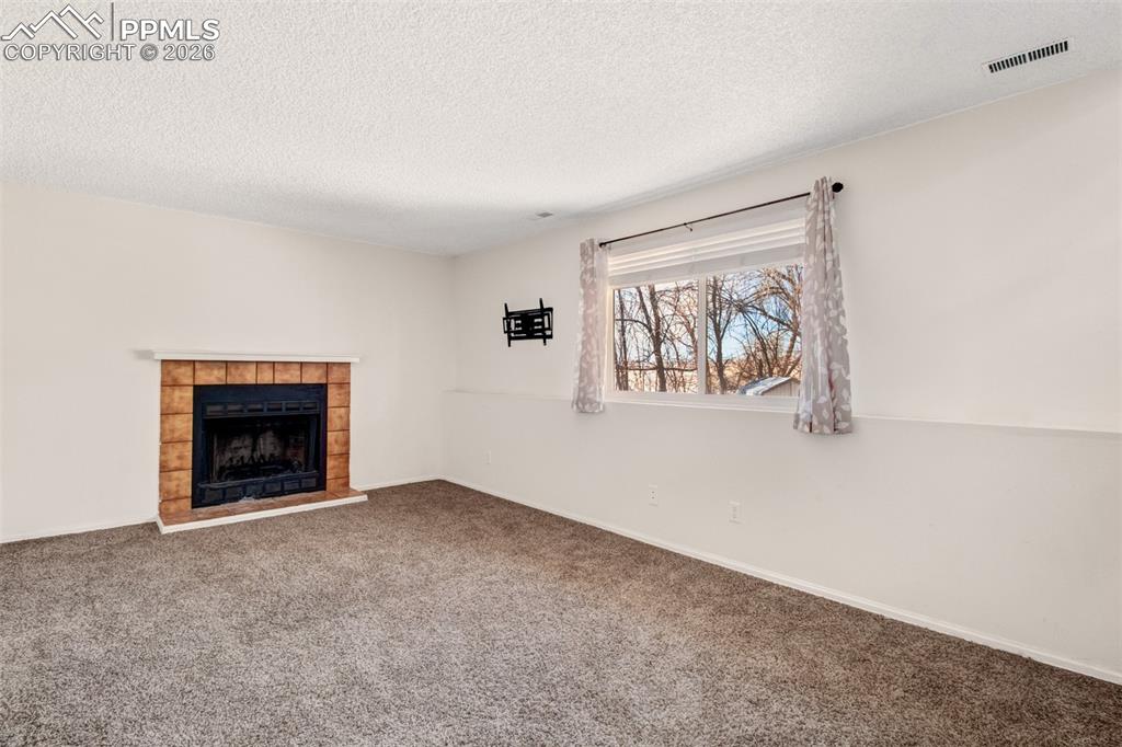 Image 11 of 35: Family Room with woodburning fireplace
