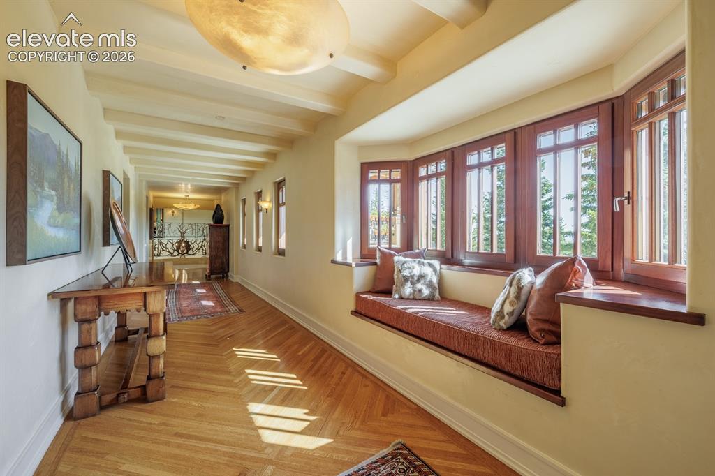 Image 16 of 49: Office/sitting room adjacent to primary suite and coffee bar with dishwashe