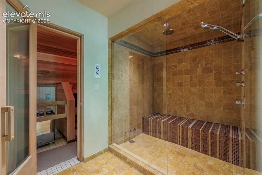 Image 25 of 49: Spa with steam shower and steam room off game room and onto exercise room