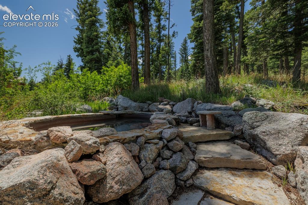 Image 27 of 49: Exercise room, walk out to terrace and up natural stone steps to out door i