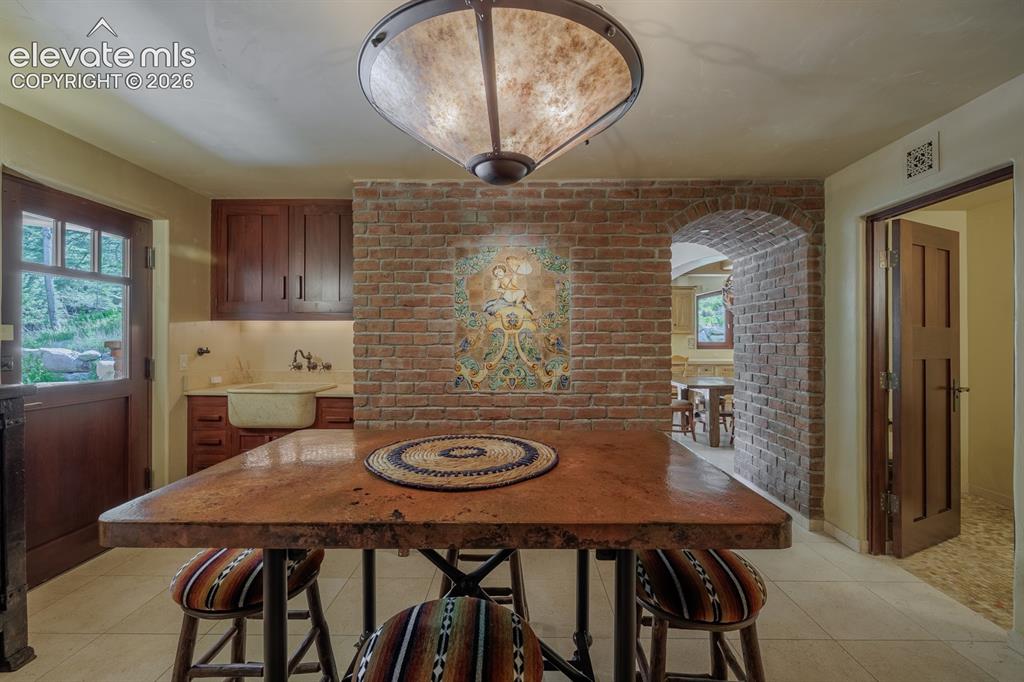 Image 38 of 49: Kitchen nook and family room access to out door patio through dutch door an