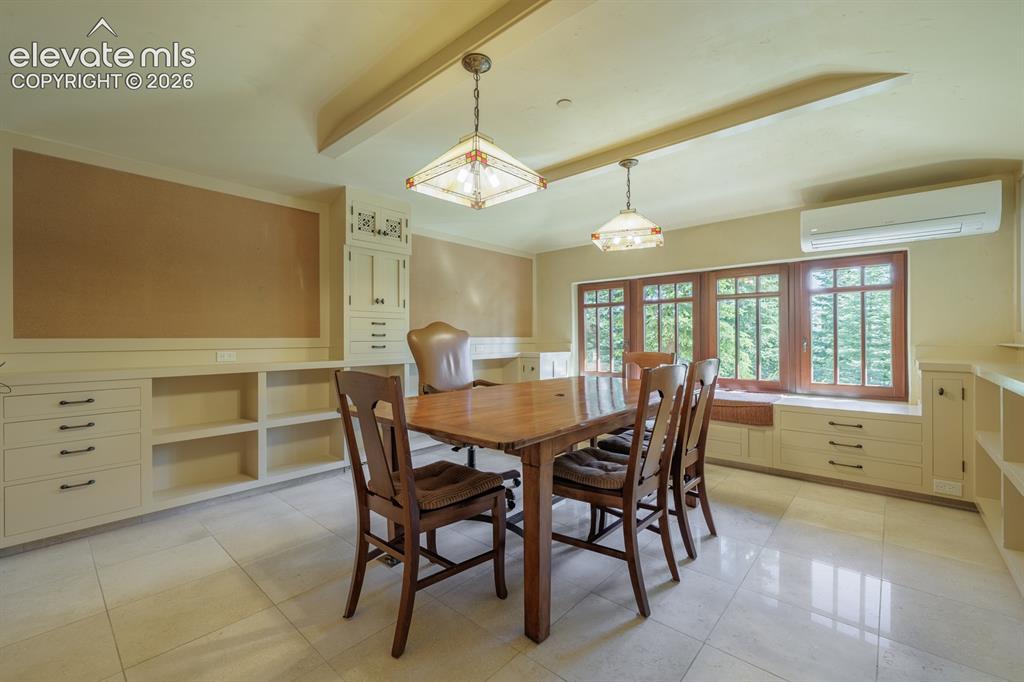 Image 39 of 49: Brick mudroom off the kitchen with guest bath and inlaid tile