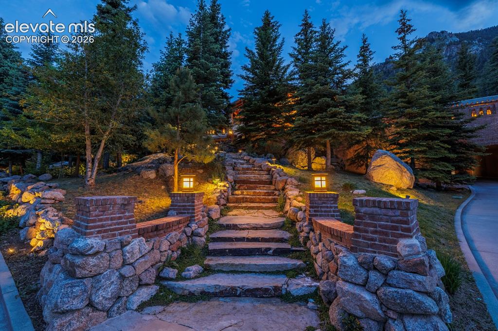Image 5 of 49: Stunning backdrop of Cheyenne Mountain. Extensive landscape lighting