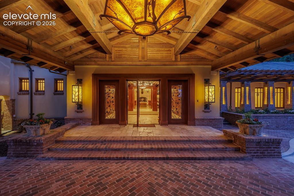 Image 6 of 49: Use of natural Colorado stone leading up this exterior stairway to the home