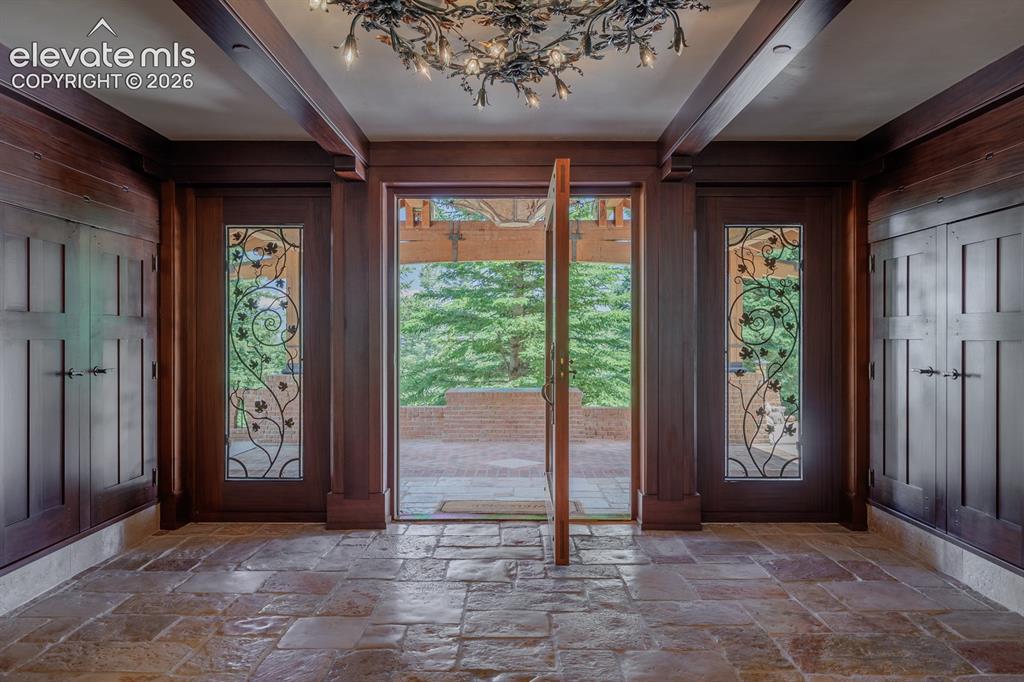 Image 7 of 49: Custom chandelier drops from the porte-cochere showcasing New Mexican black