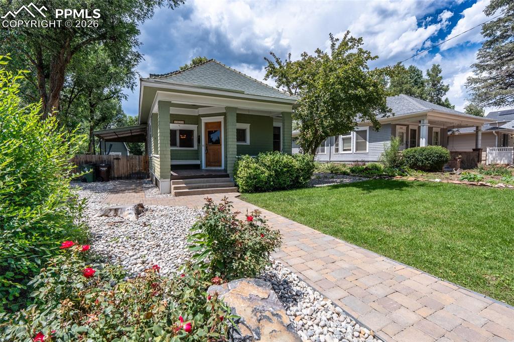 Image 1 of 24: View of front of home featuring a porch and a shingled roof