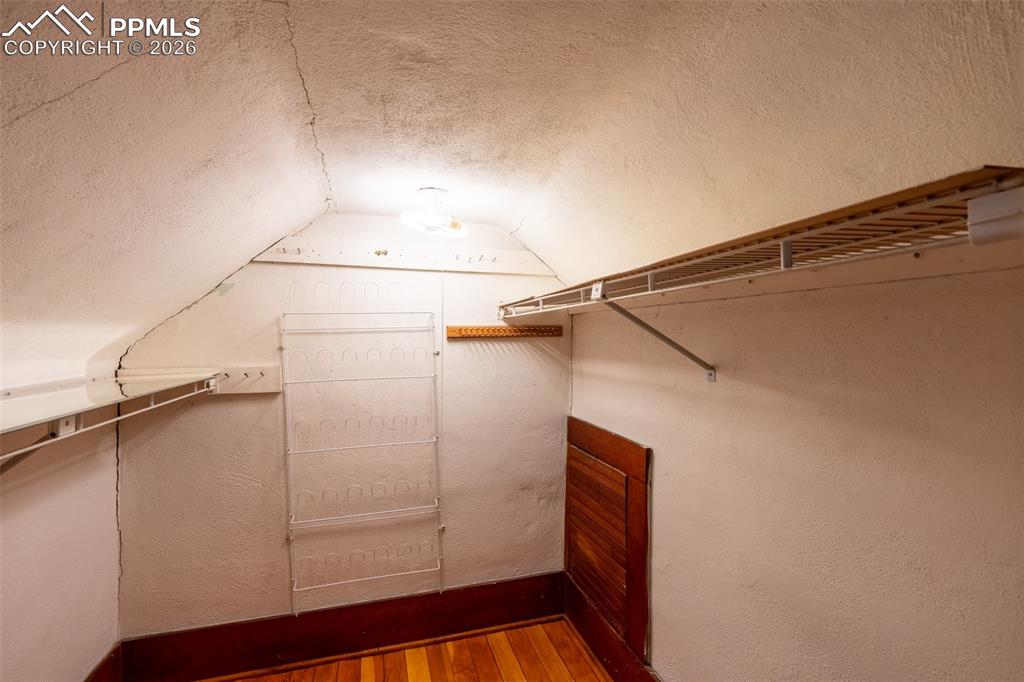 Image 18 of 24: Walk in closet featuring wood finished floors