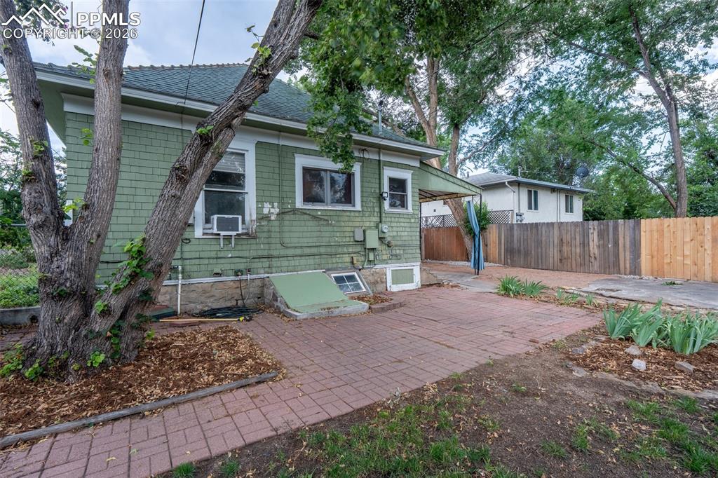 Image 20 of 24: Rear view of house featuring a patio, roof with shingles, and cooling unit