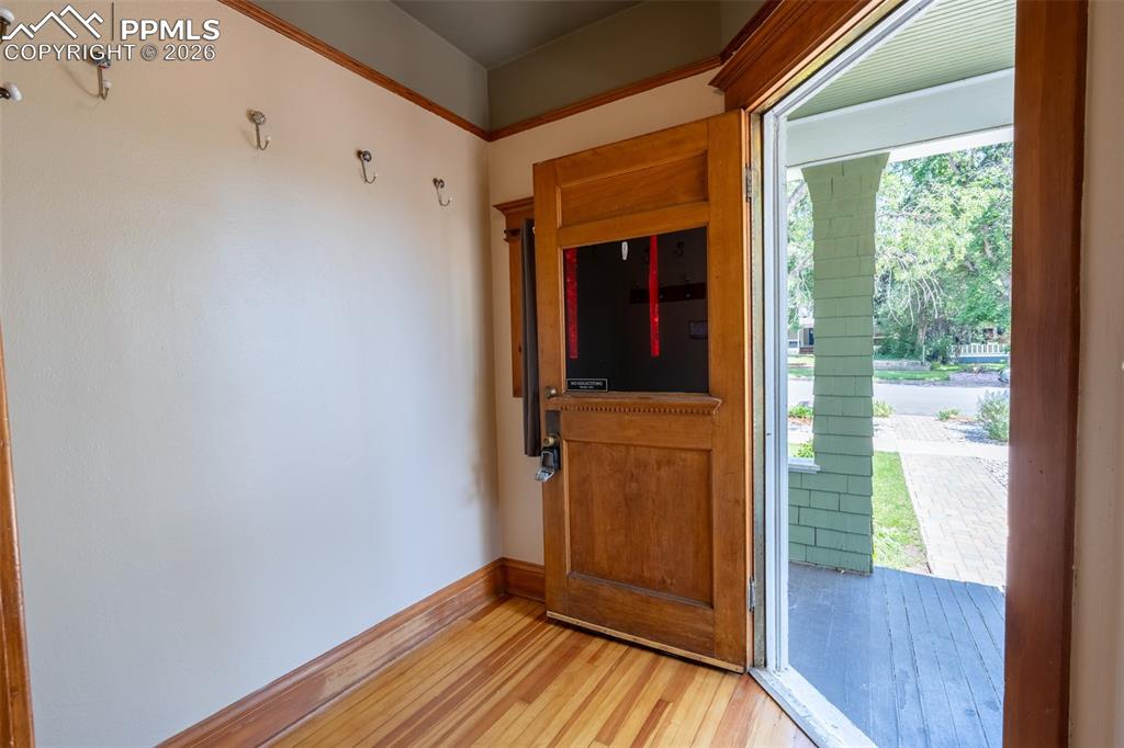 Image 3 of 24: Foyer entrance with light wood finished floors and baseboards