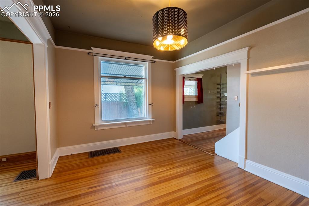 Image 7 of 24: Dining room featuring light wood-style flooring and hanging lights