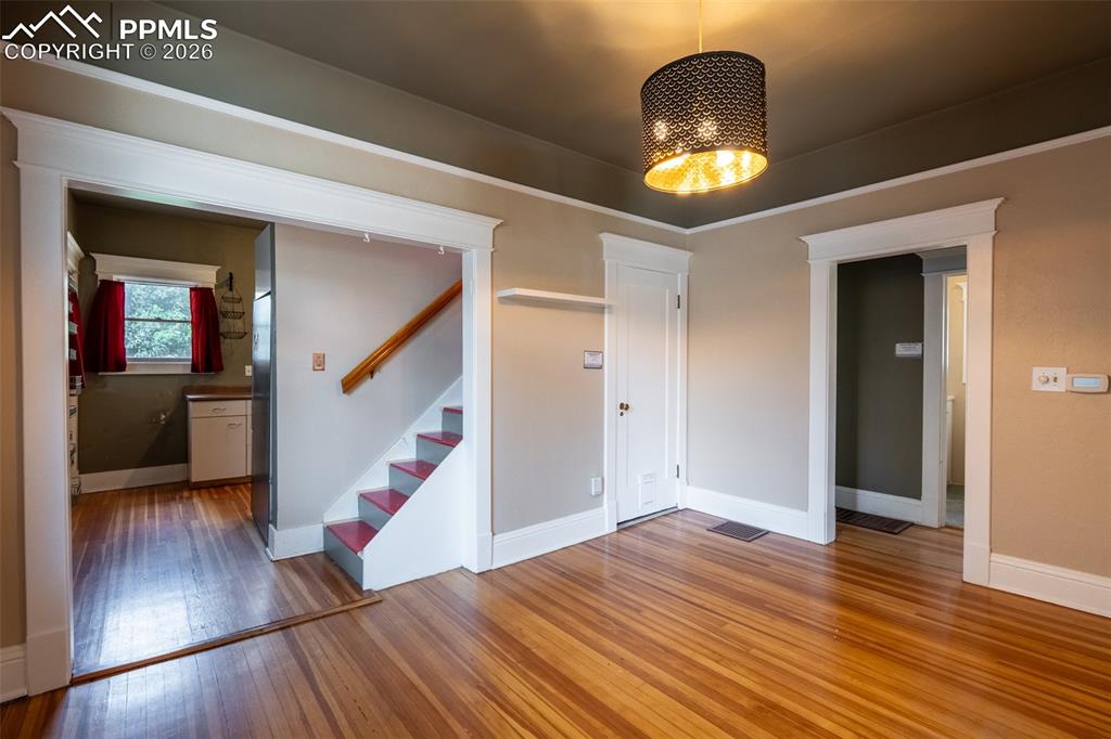Image 8 of 24: Dining room featuring light wood-style flooring and hanging lights