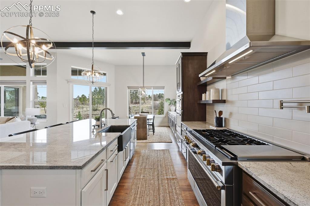 Image 10 of 39: Spacious kitchen featuring a large island with an undermount farmhouse sink