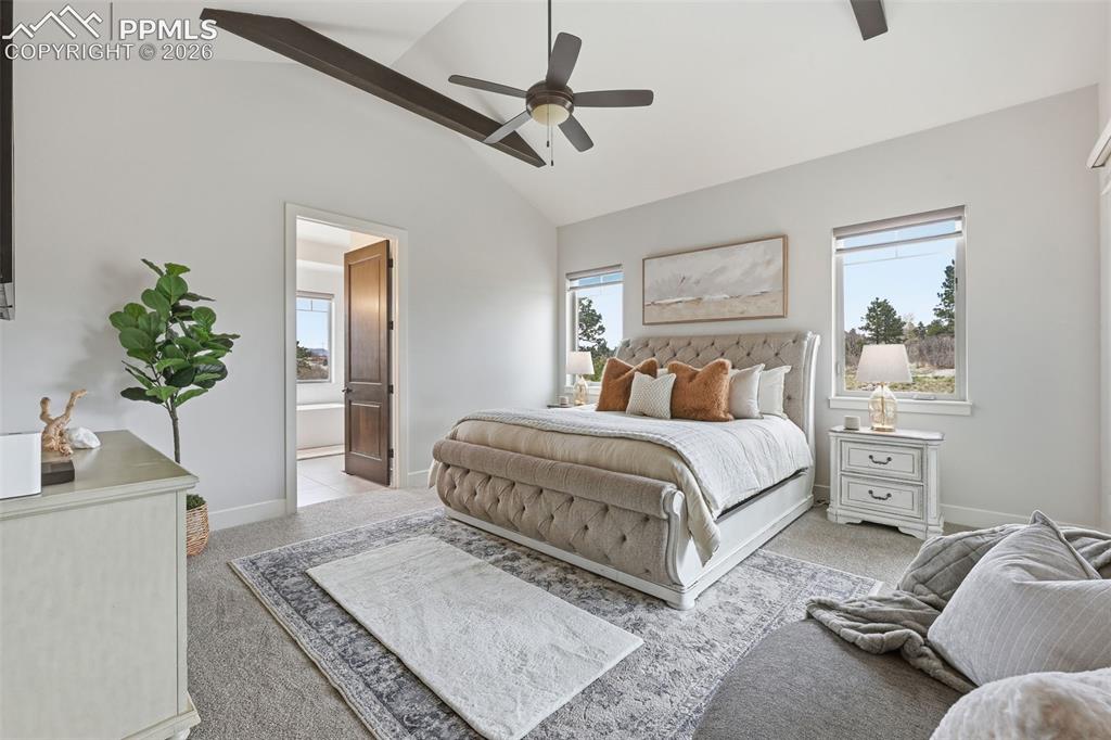 Image 16 of 39: Vaulted ceiling with exposed wood beams and ceiling fan