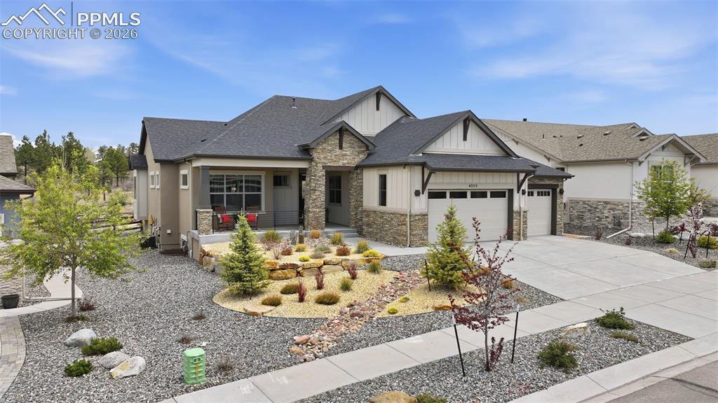 Image 2 of 39: Contemporary home featuring a combination of stone and siding facade on .28