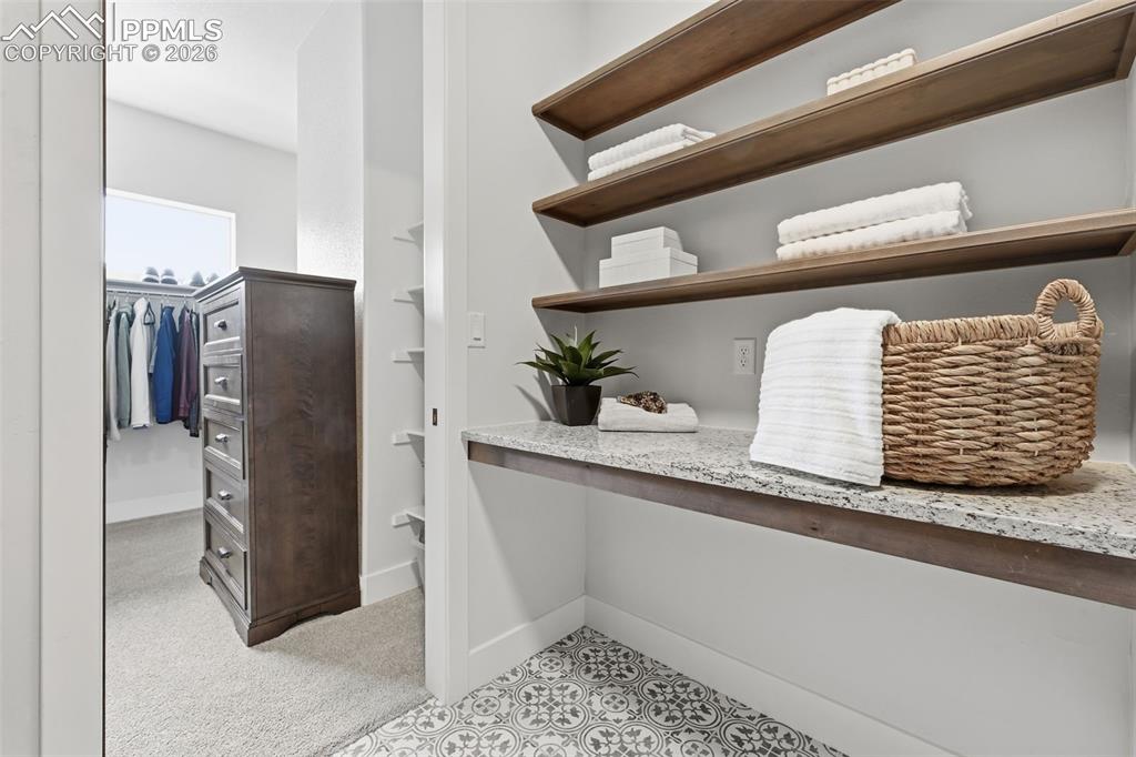 Image 20 of 39: Pass through laundry from primary bedroom, bathroom and closet with built i