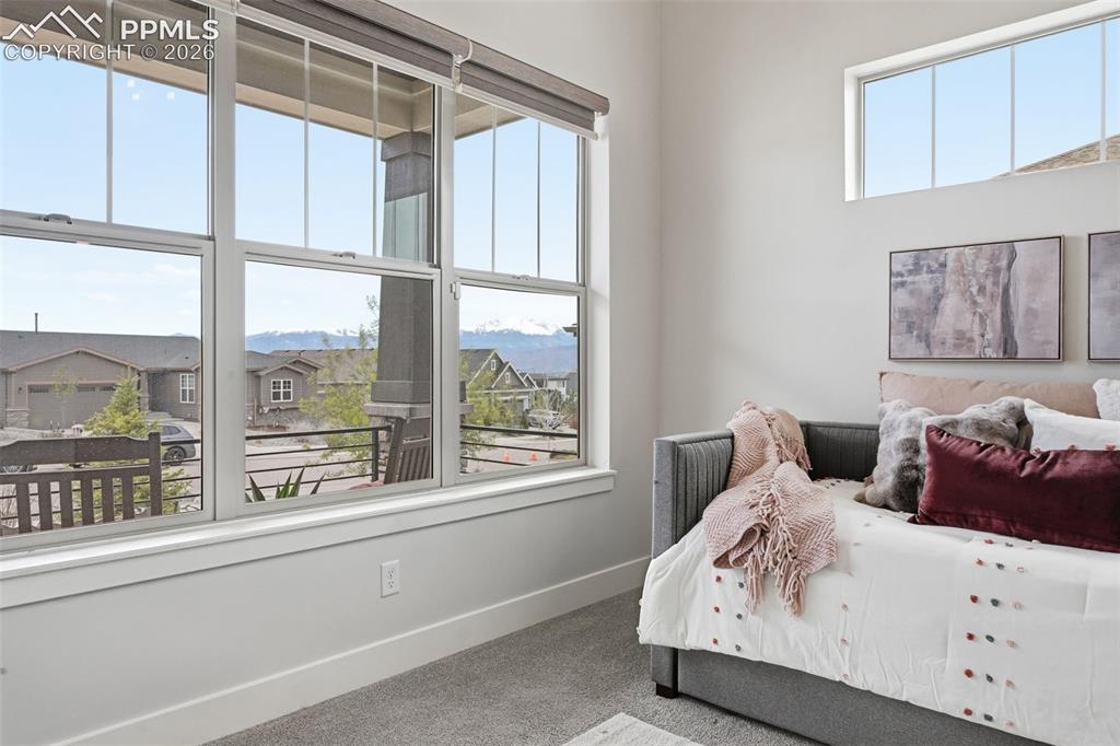 Image 24 of 39: Expansive window wall with multiple panes, offering distant mountain scener