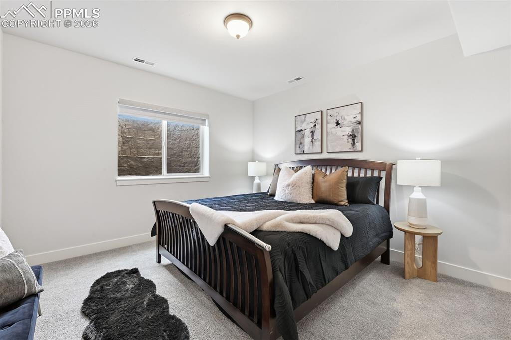 Image 33 of 39: Carpeted room featuring a white window frame, white baseboards, and a semi-