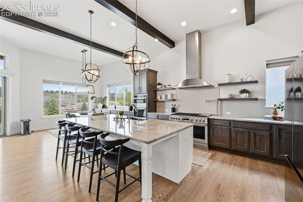 Image 8 of 39: Gourmet kitchen featuring a large island with seating, stainless steel appl