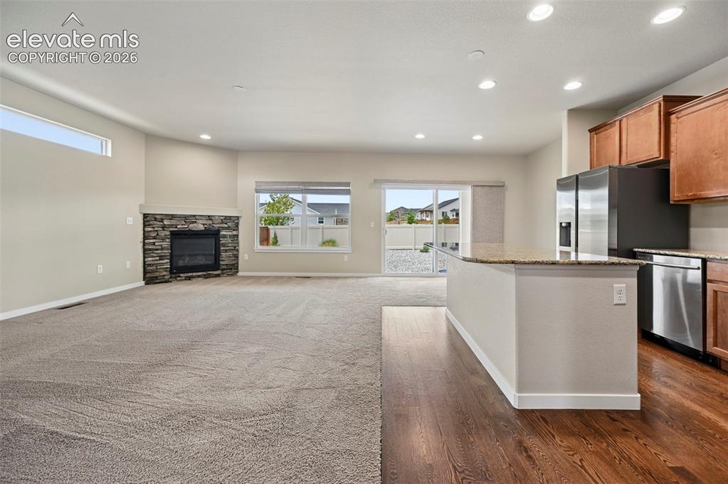 Image 10 of 44: Living room looking at kitchen
