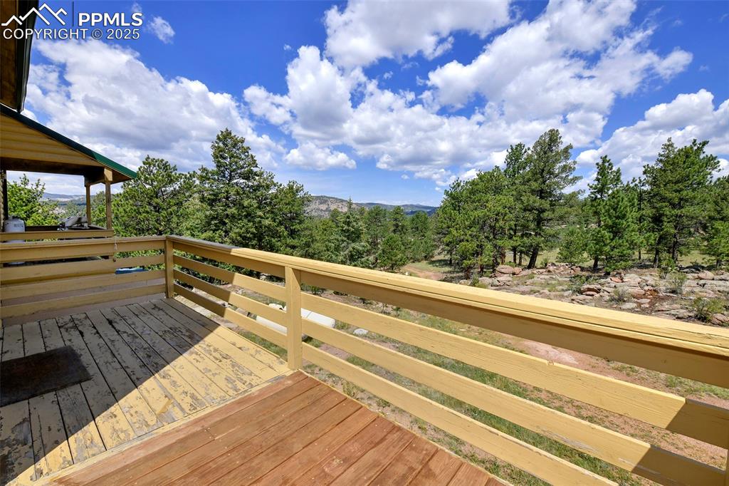 Image 12 of 48: Deck With Views Of The Trees, Rocks, And Mountains 