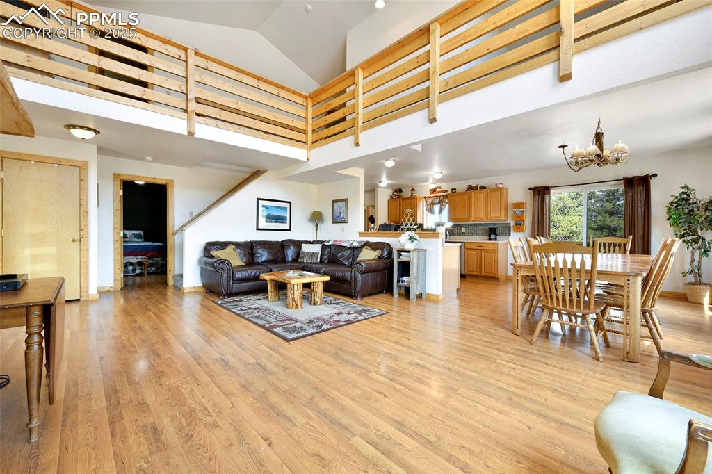 Image 13 of 48: Main Level Great Room With View Into Kitchen And Upper Level Hallway