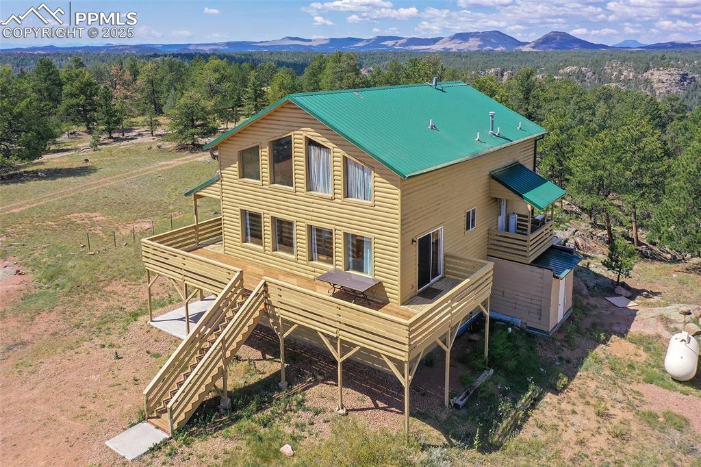 Image 42 of 48: Front And Side Of Home With View Of Mountains And Trees 
